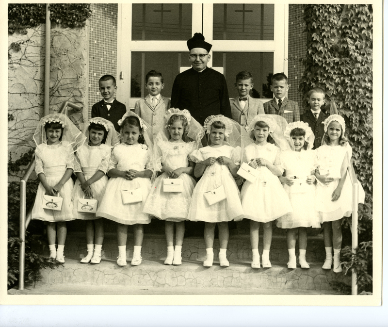 Young Girls at Church in their First Communion Dresses with the Reverend 