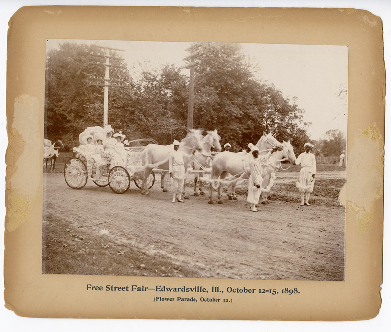 1898 Photograph of Julia Hadley, Mary Hadley, Florence Brink, Mrs. E. I. Prickett in a Carriage, and Four Men Standing during the Free Street Fair Flower Parade