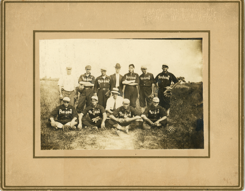 Men wearing baseball uniforms with "Paragon" 