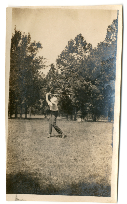 Photograph of a man swinging a golf club