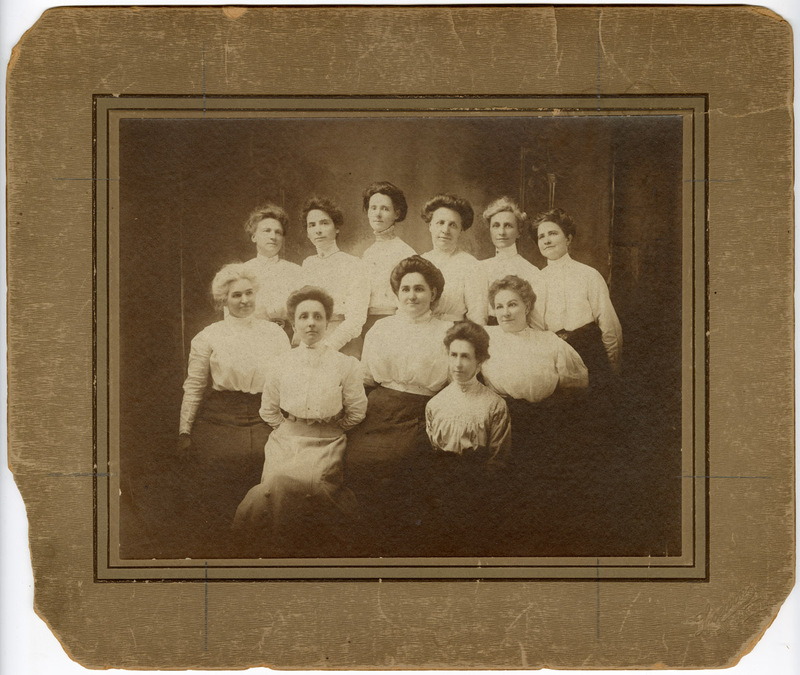 Photograph of Eleven Women in Shirtwaists with a Swastika Pin