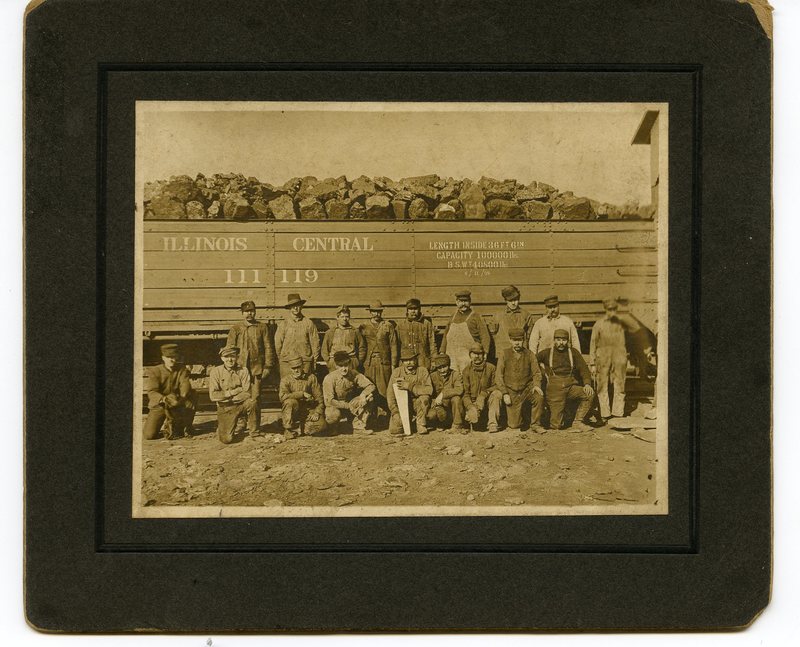 Coal Miners in front of railroad car filled with coal
