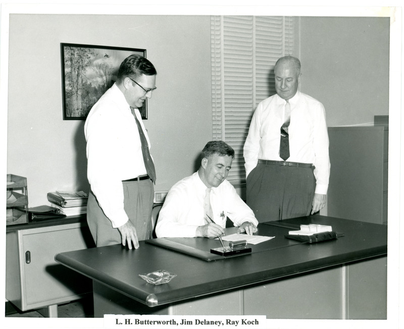 L.H. Butterworth, Jim Delaney and Ray Koch at Desk in Office 