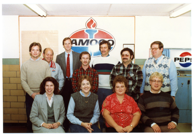 1980s Group Photograph Indoors in Front of Amoco Sign