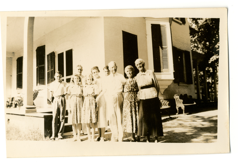 Photograph of nine people outside the Mudge home (Oakdale) on the Mudge farm in Grantfork