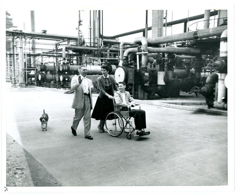 Gev Nauyork, Dorothy Lyons, and Mr. Lyons with Dog Tour the Standard Oil Refinery
