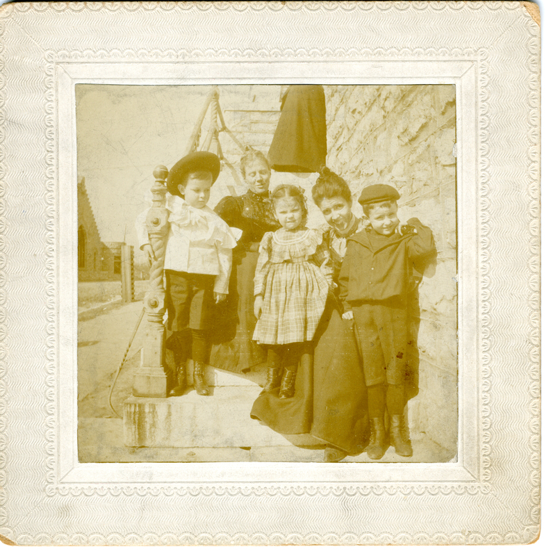 Photograph of two women with three children