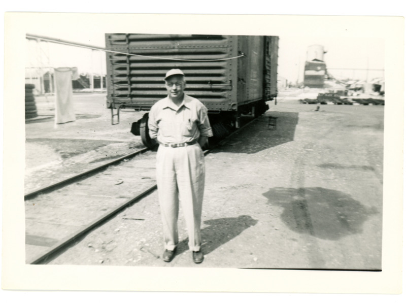 1952 Man Posing in Front of Boxcar