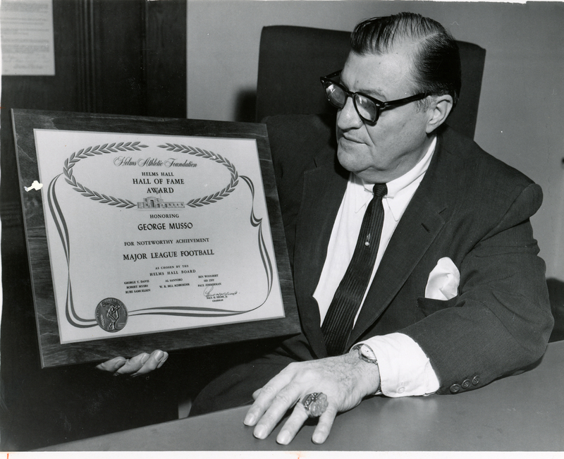 George Musso holding Helms Hall, Hall of Fame Award