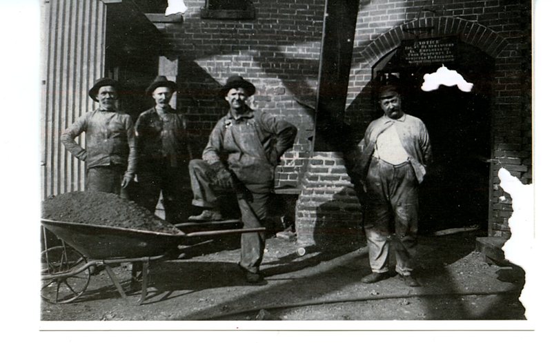 Coal miners standing outside of the boiler room at mine #2 in Glen Carbon, Illinois