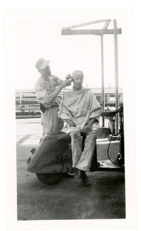 1952 Man Getting Haircut in Refinery Yard During Standard Oil Strike