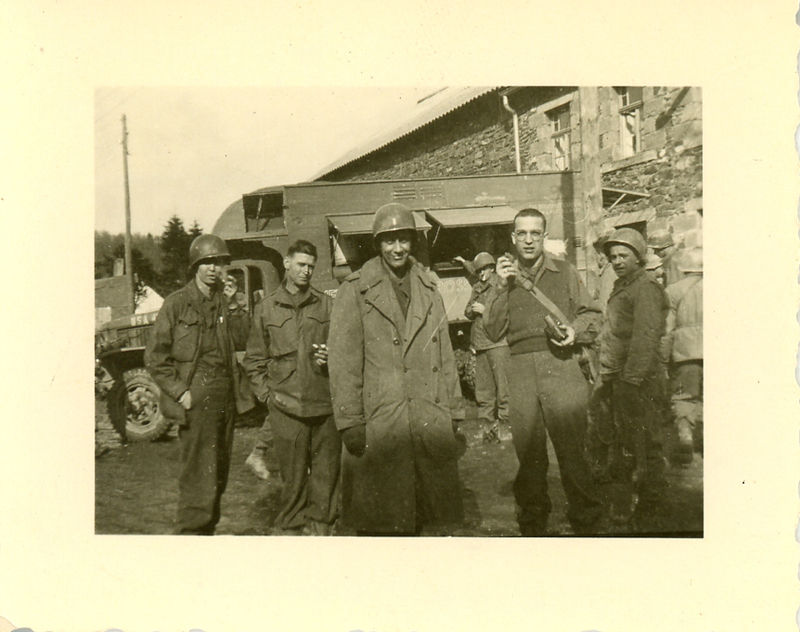 Ray Bieser and other men in front of the Red Cross Club-mobile in Belgium 