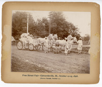 1898 Photograph of Julia Hadley, Mary Hadley, Florence Brink, Mrs. E. I. Prickett in a Carriage, and Four Men Standing during the Free Street Fair Flower Parade