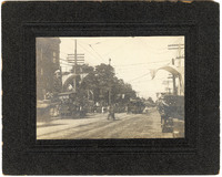 1912 Photograph of a Street Scene with Trucks and a Trolley During the Madison County Centennial Celebration