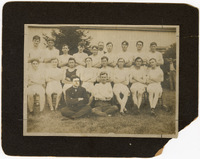 Photograph of Three Rows of Men in White Athletic Uniforms Sitting with Arms Crossed