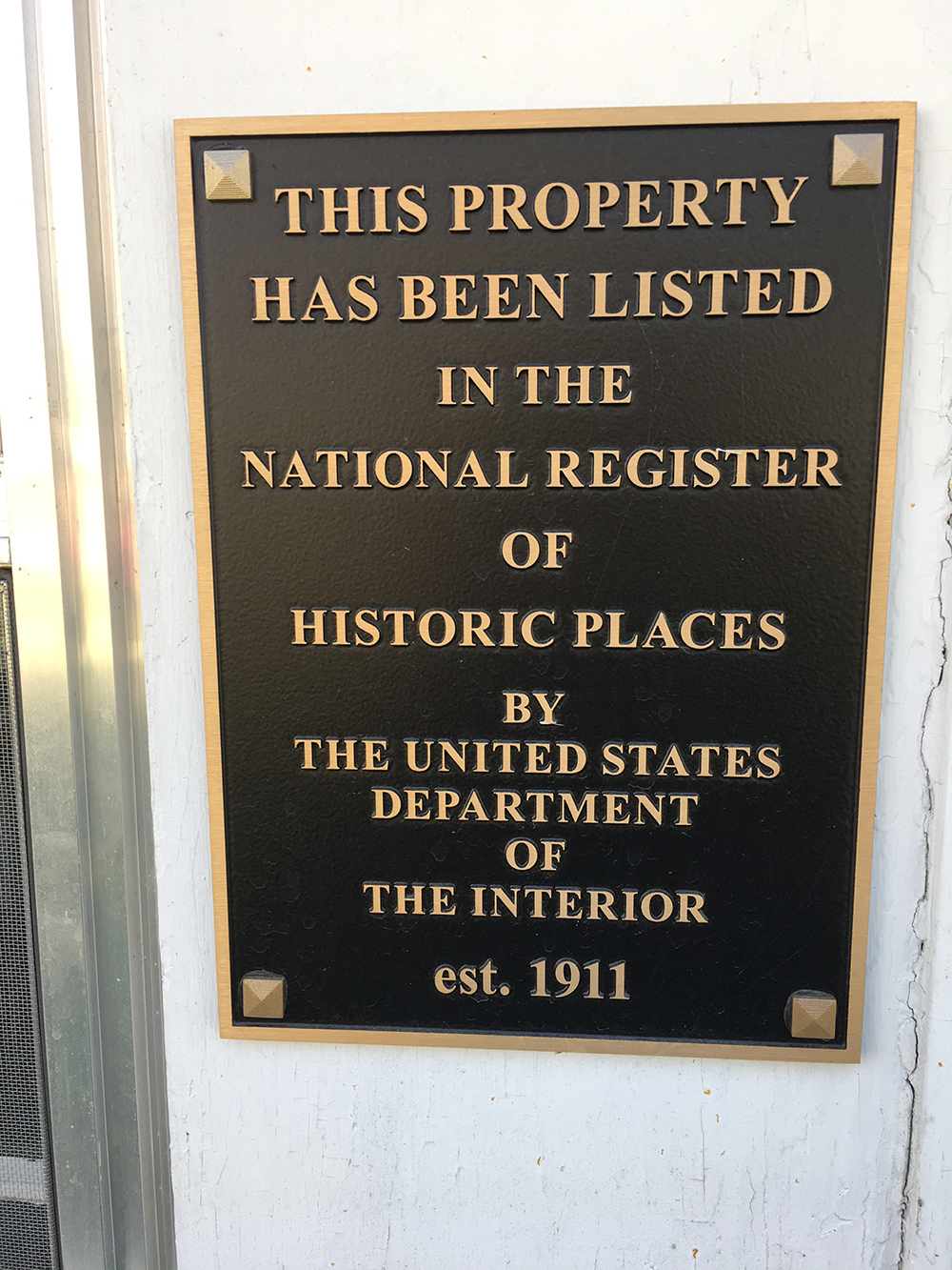 Marker on the Charles Gravius Memorial Library. It reads, This property has been listed in the national register of historical places by the untied states department of the interior, established 1911